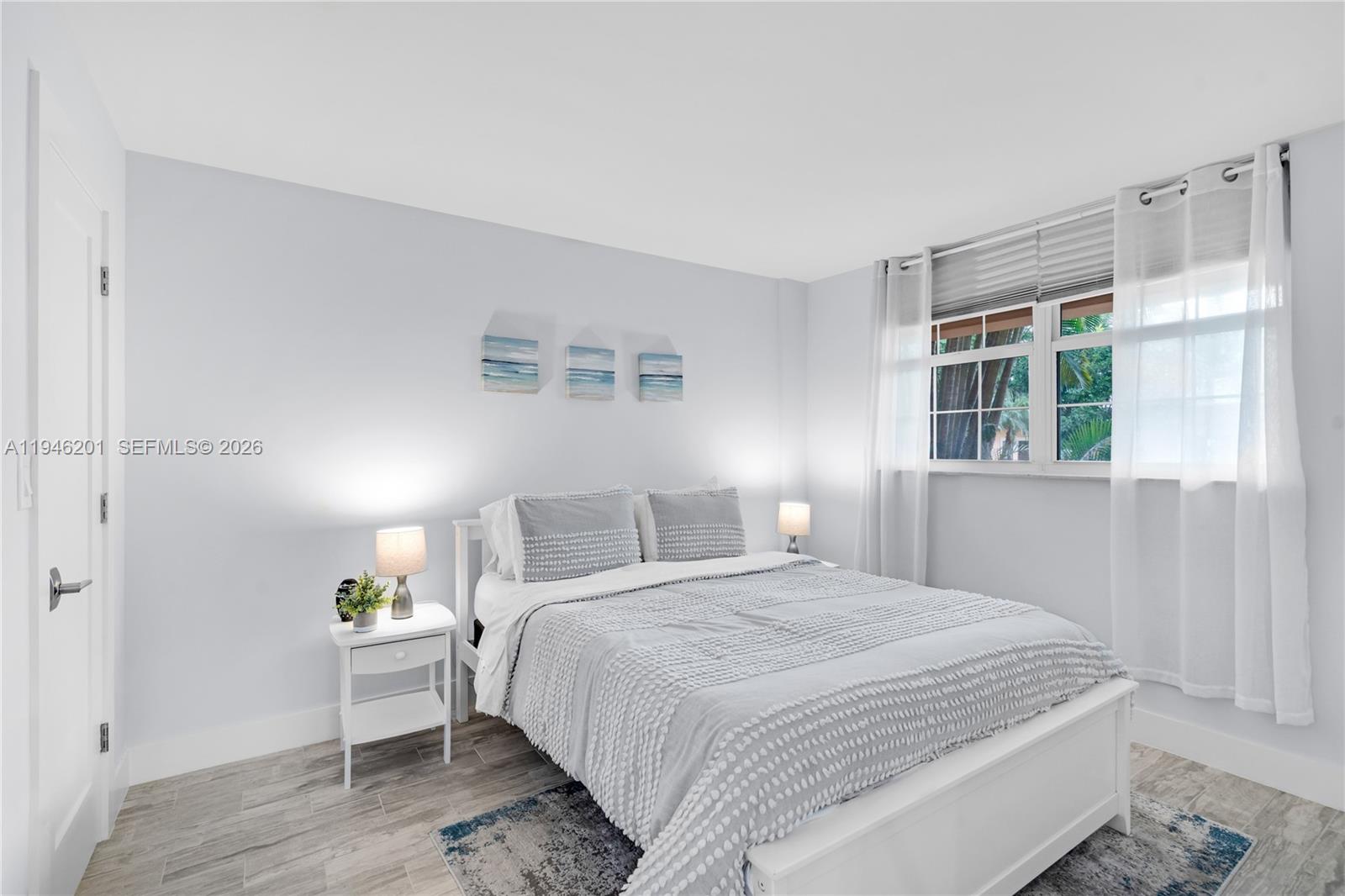 4502 North Federal Highway, Unit 167H Lighthouse Point, FL 33064 - Photo 15 of 31 a bedroom with a bed and a window