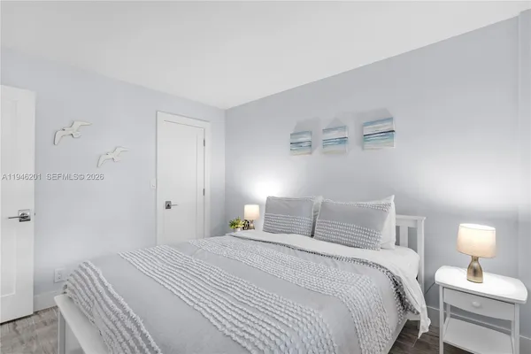 a bedroom with a bed and a night lamp