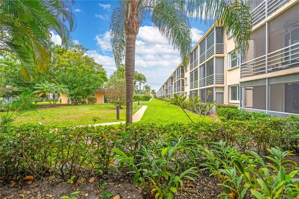 a view of a garden with a building in the background