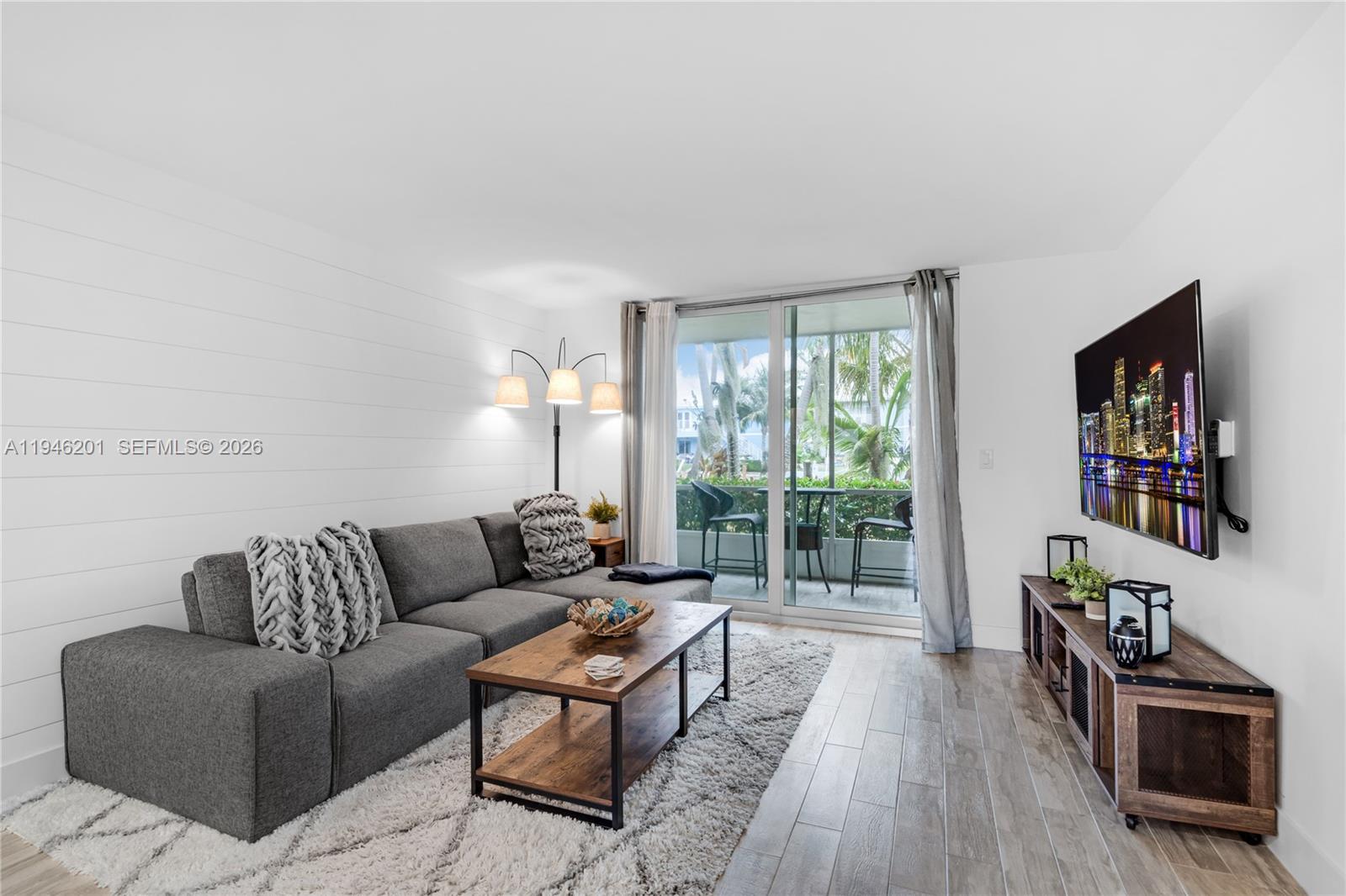 4502 North Federal Highway, Unit 167H Lighthouse Point, FL 33064 - Photo 3 of 31 a living room with furniture and a wooden floor