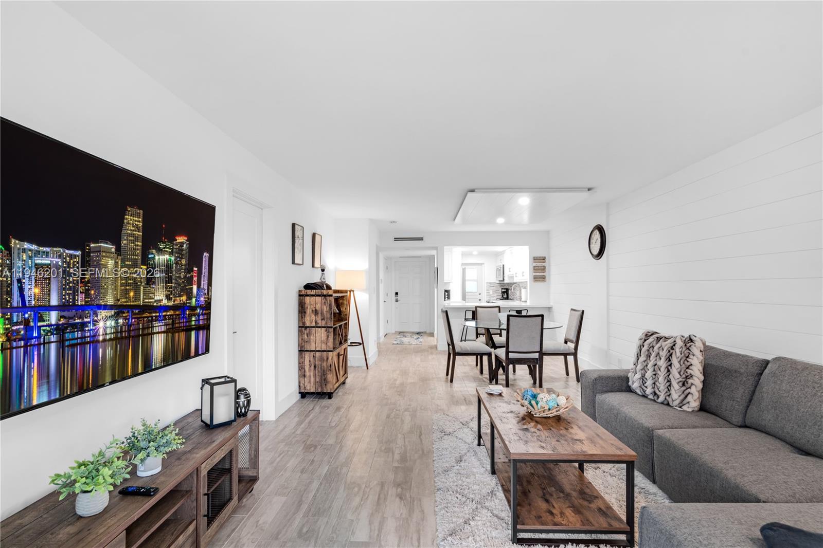 4502 North Federal Highway, Unit 167H Lighthouse Point, FL 33064 - Photo 4 of 31 a living room with furniture and a wooden floor