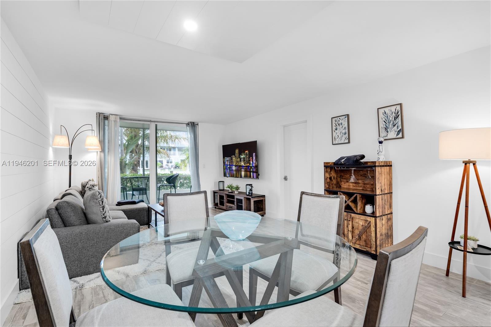 4502 North Federal Highway, Unit 167H Lighthouse Point, FL 33064 - Photo 5 of 31 a living room with furniture a fireplace and a large window