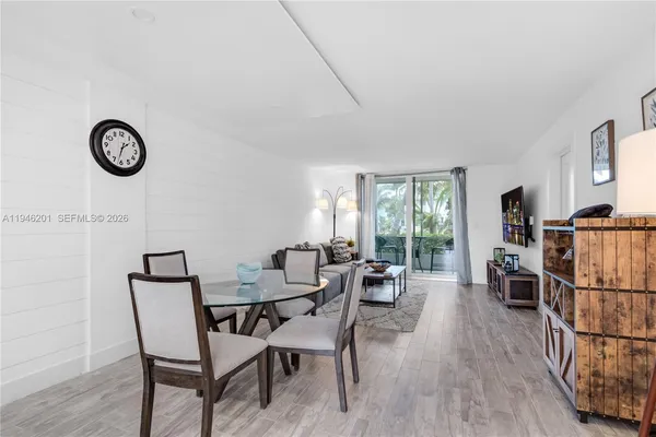 a view of a dining room with furniture window and wooden floor