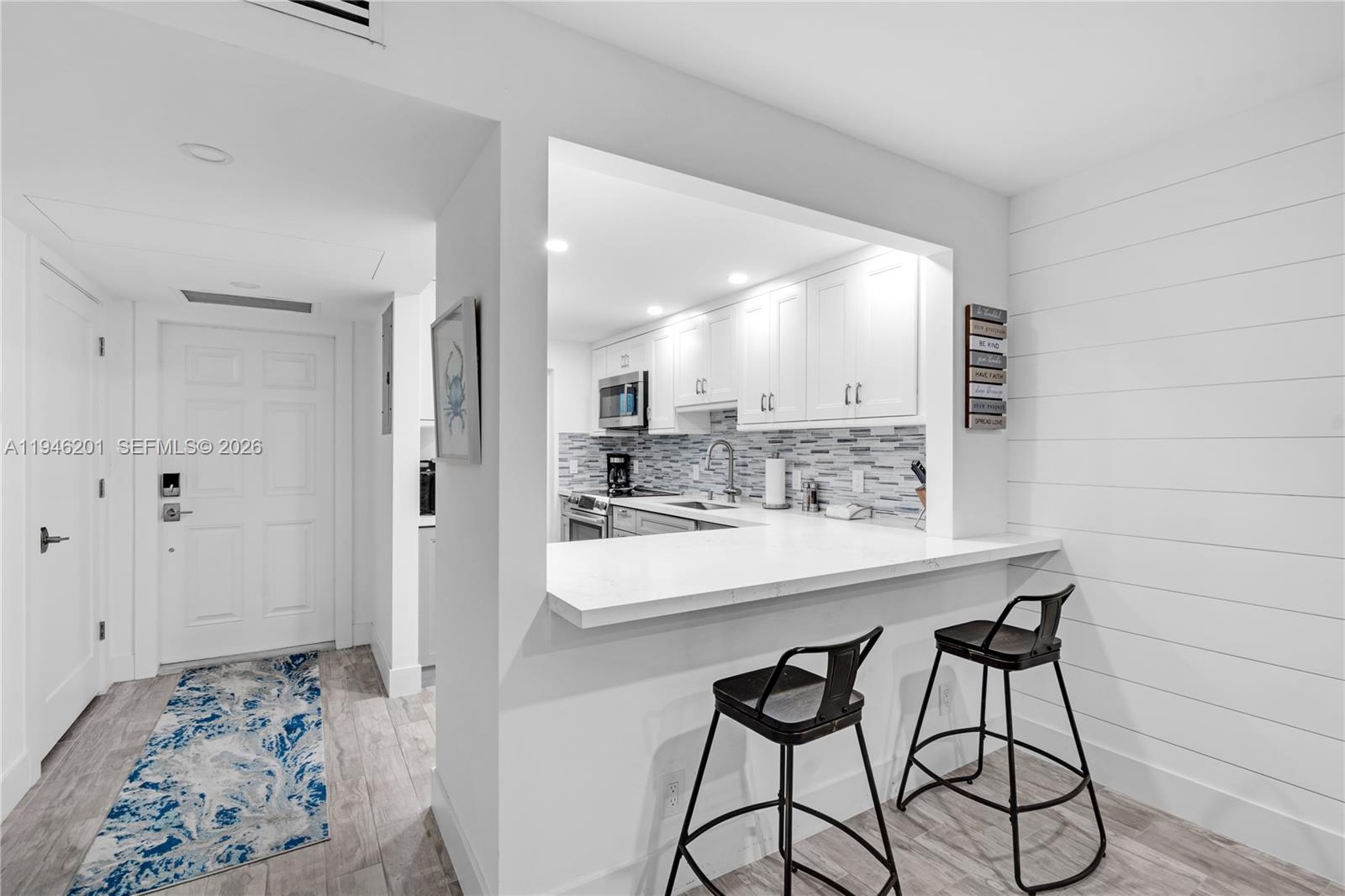 4502 North Federal Highway, Unit 167H Lighthouse Point, FL 33064 - Photo 9 of 31 a view of a kitchen from the hallway