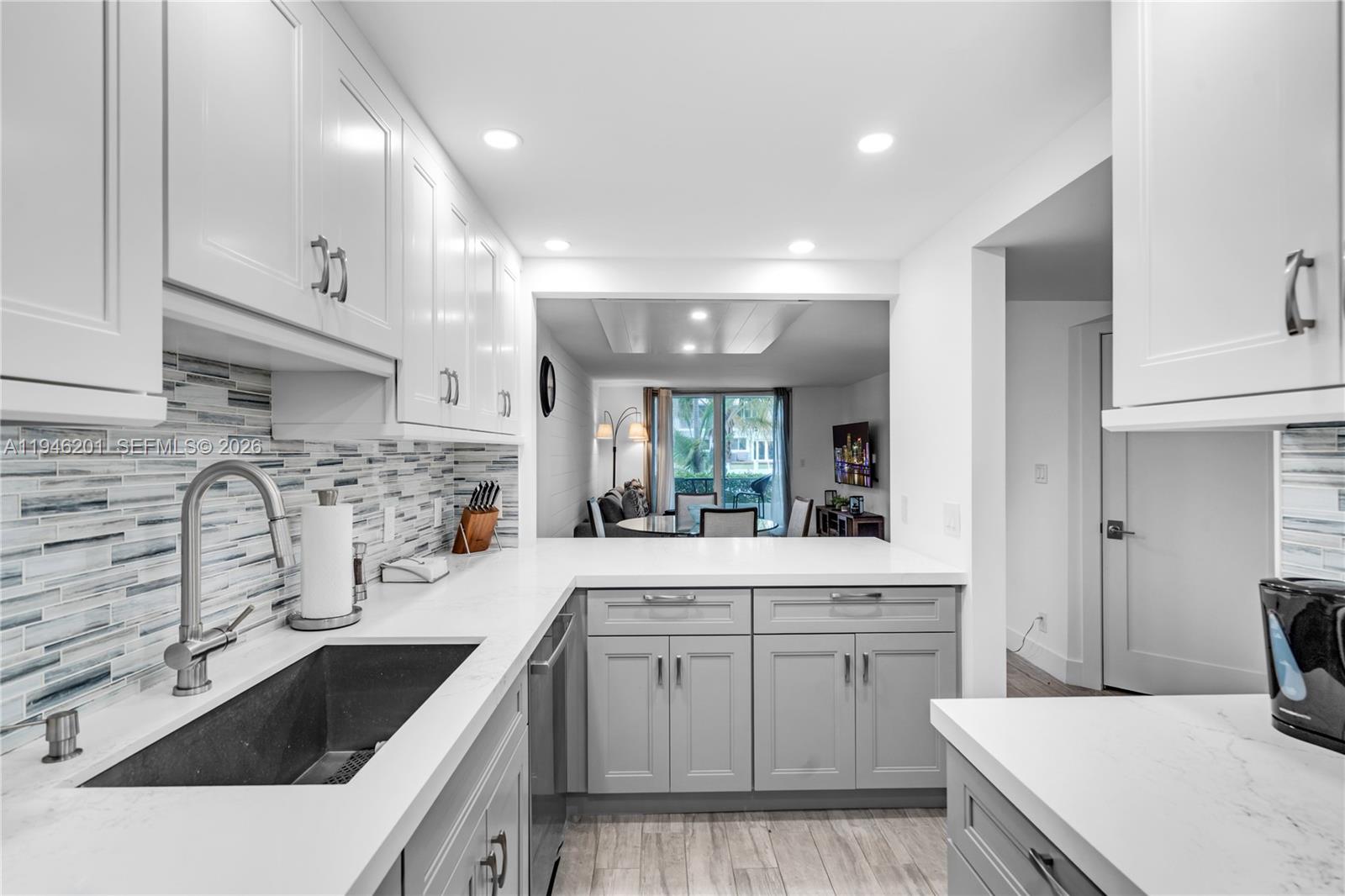4502 North Federal Highway, Unit 167H Lighthouse Point, FL 33064 - Photo 10 of 31 a kitchen with stainless steel appliances kitchen island granite countertop a sink stove and cabinets