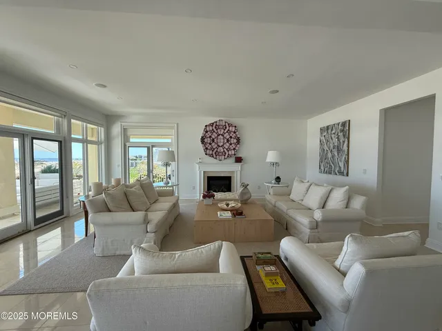a living room with furniture a large window and a fireplace