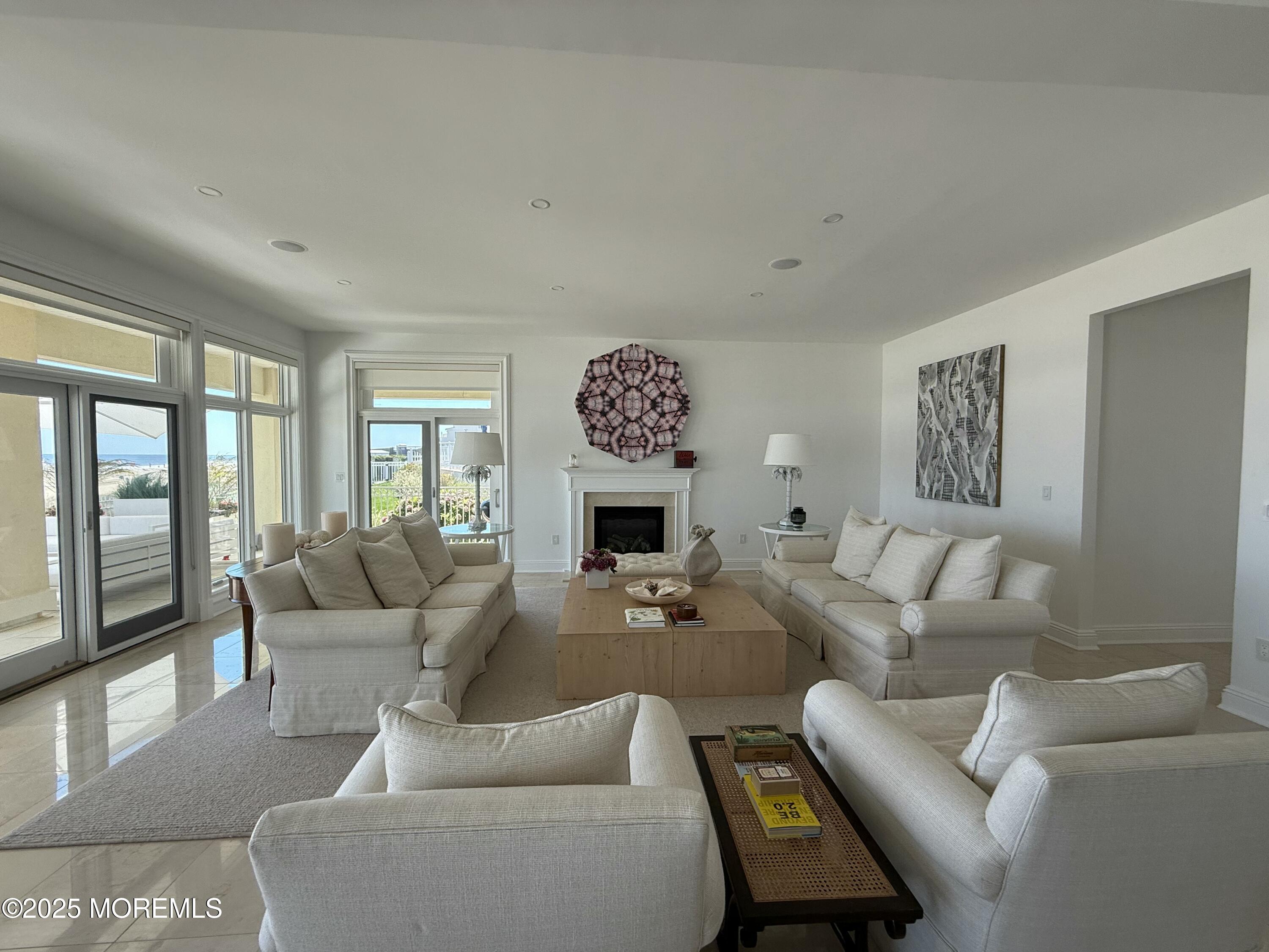 31 Riviera Drive Long Branch, NJ 07740 - Photo 4 of 12 a living room with furniture a large window and a fireplace