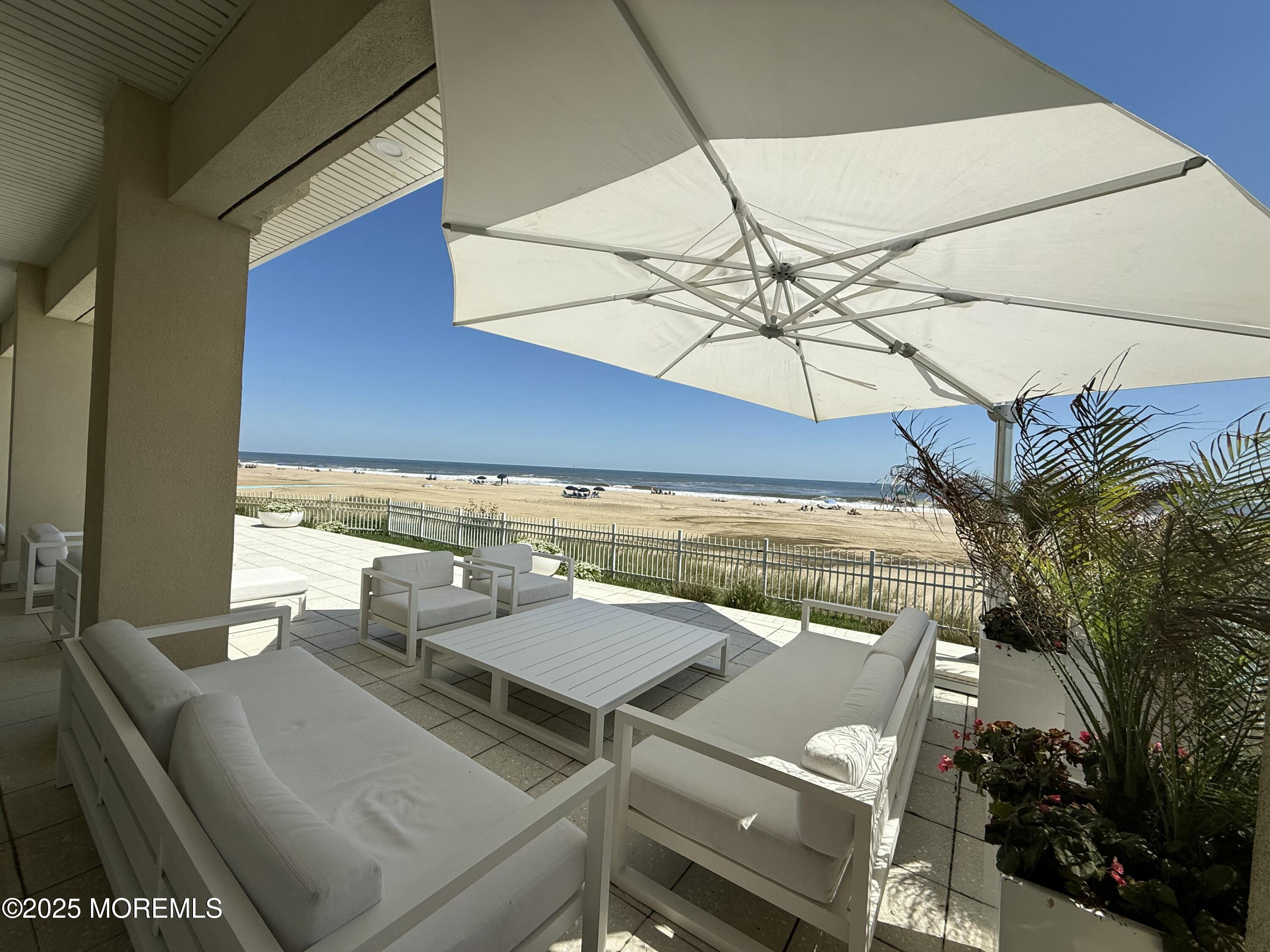 31 Riviera Drive Long Branch, NJ 07740 - Photo 6 of 12 a roof deck with a table and chairs under an umbrella