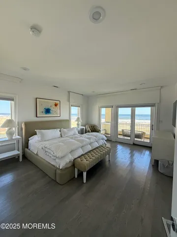 a spacious bedroom with a bed couch and a large window