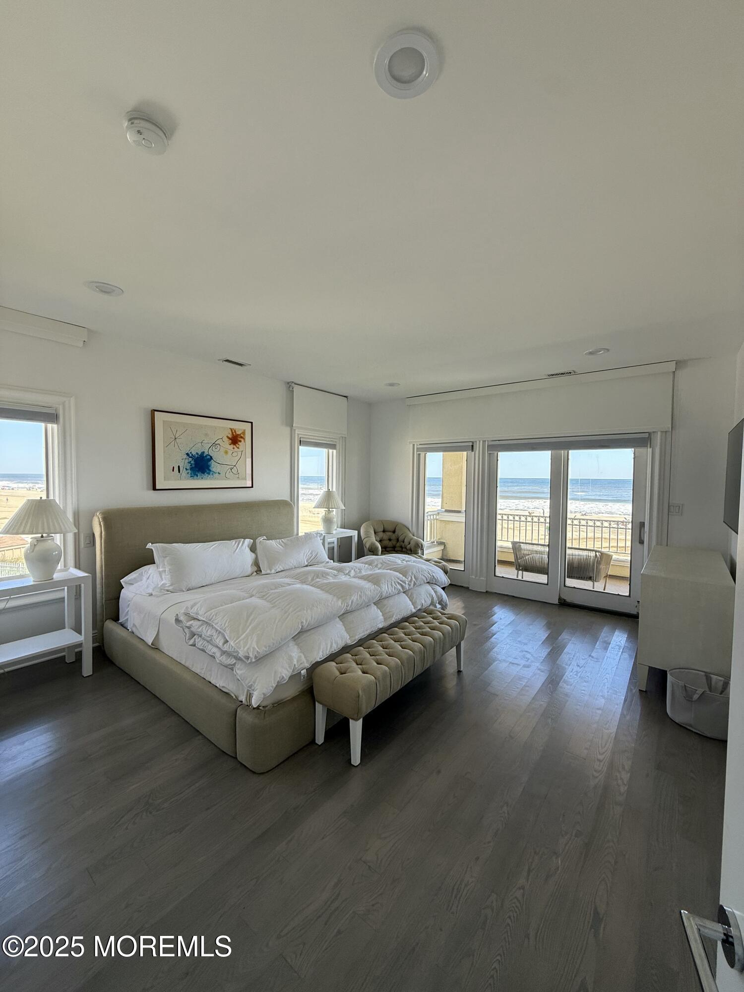 31 Riviera Drive Long Branch, NJ 07740 - Photo 9 of 12 a spacious bedroom with a bed couch and a large window