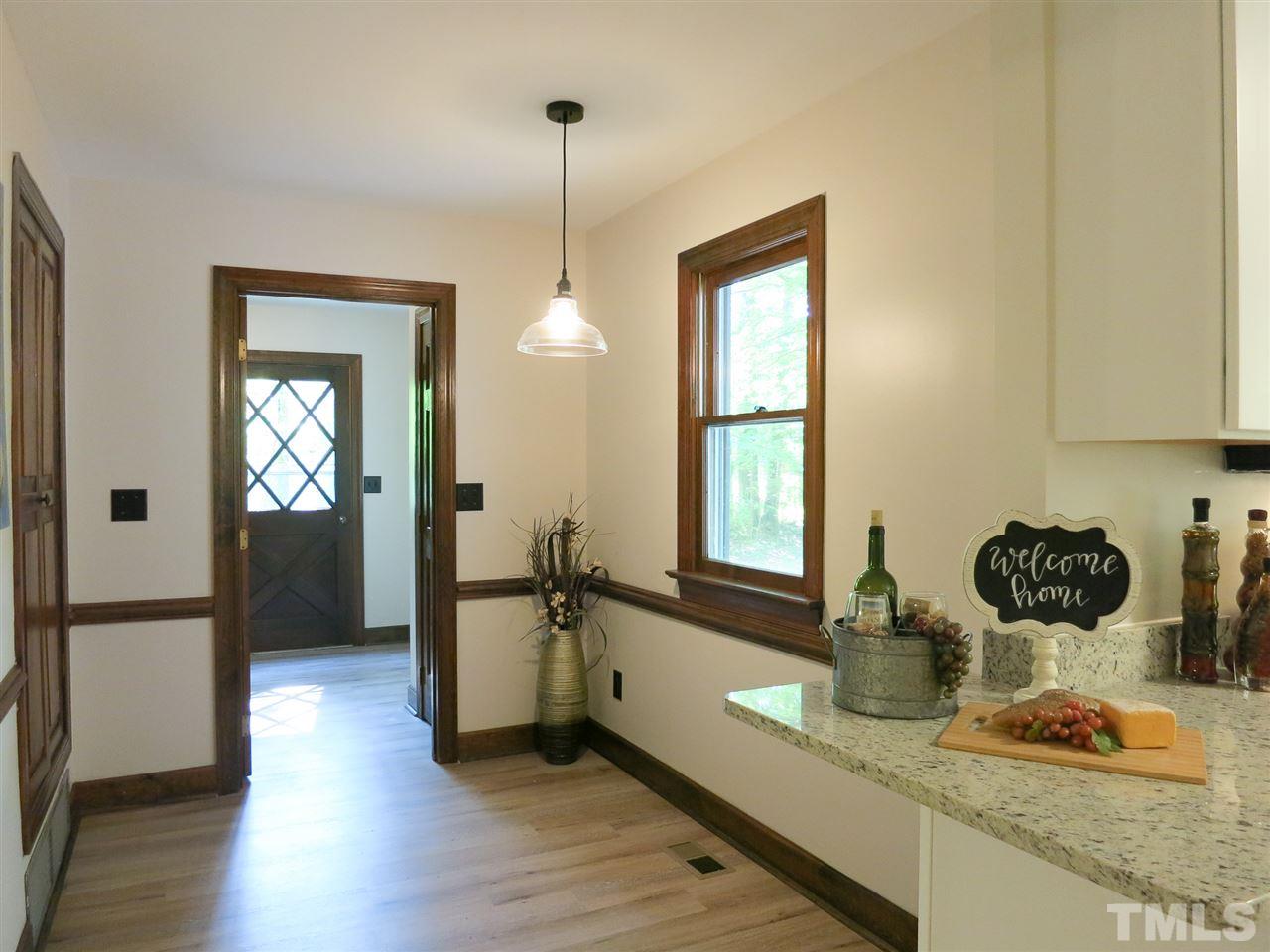 809 Ivanhoe Drive Raleigh, NC 27615 - Photo 15 of 30 Kitchen open to Bfast Rm w/pantry, NEW light fixture & LVP flooring.