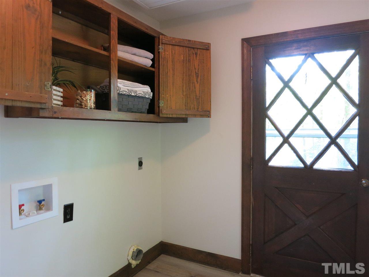 809 Ivanhoe Drive Raleigh, NC 27615 - Photo 17 of 30 Adjacent Laundry/Mud Rm w/LVP flooring, closet & wall cabinets exits to driveway.