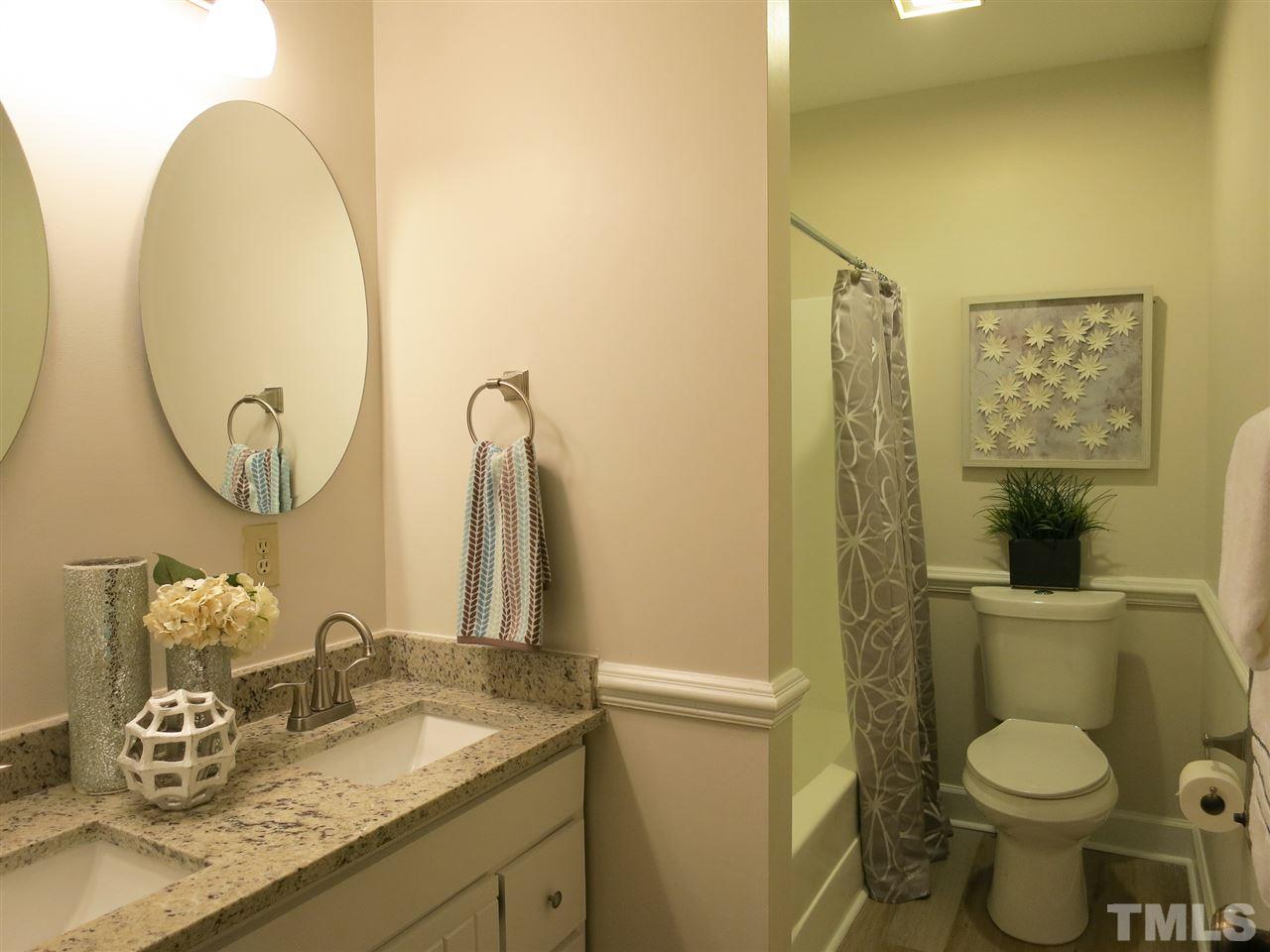 809 Ivanhoe Drive Raleigh, NC 27615 - Photo 24 of 30 The 2 Bedrooms share the Hall Bath w/granite counter top, double sinks, hardware, LVP flooring & NEW toilet.