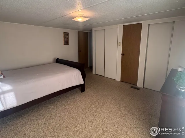 a bed sitting in a room next to a window