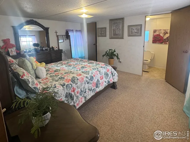 a bedroom with a bed and a mirror