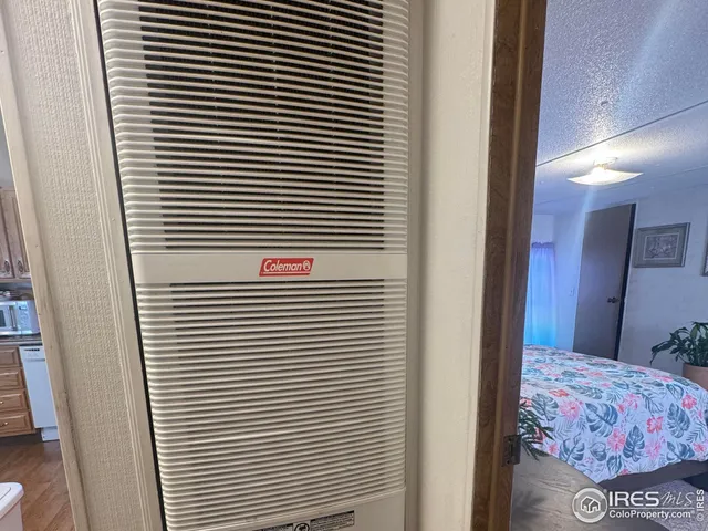 a view of a bedroom with a bed and a window