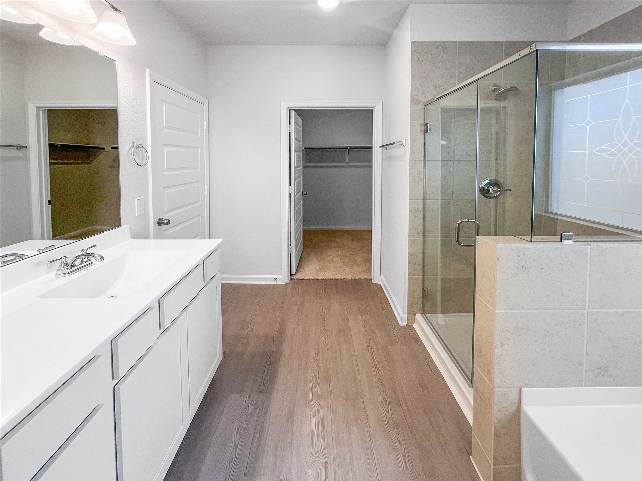 9717 Enclave Ridge Road Willis, TX 77318 - Photo 9 of 20 The Waring III- Primary Bathroom with Dual Vanities, Separate Garden tub and Walk-in Shower. Sample image for illustration; upgrades, options, and colors may vary.
