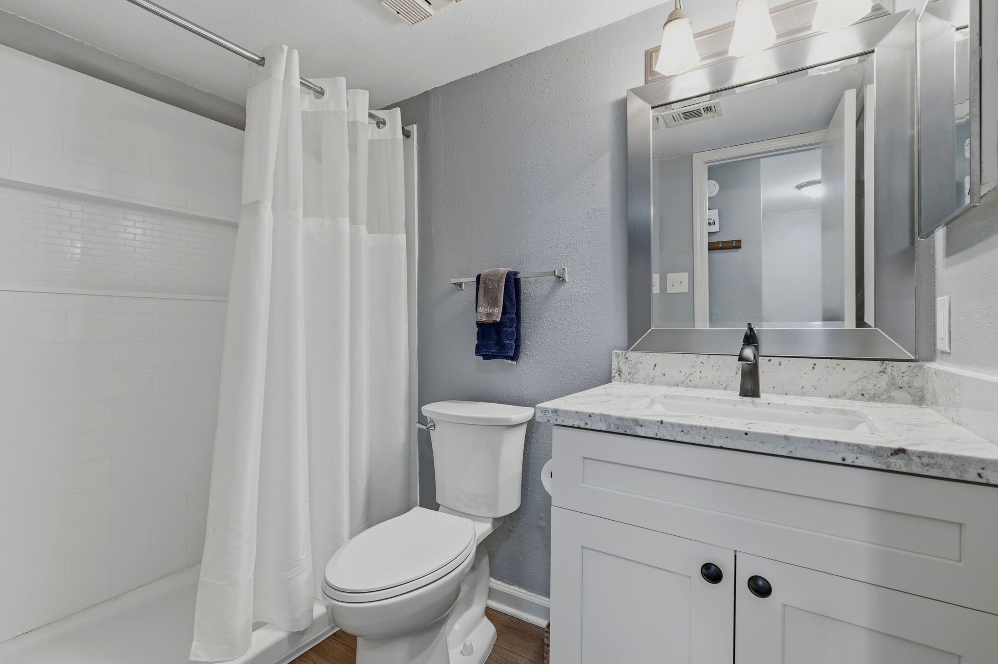 13151 Walden Road, Unit 127 Montgomery, TX 77356 - Photo 18 of 46 a bathroom with a granite countertop sink toilet and mirror