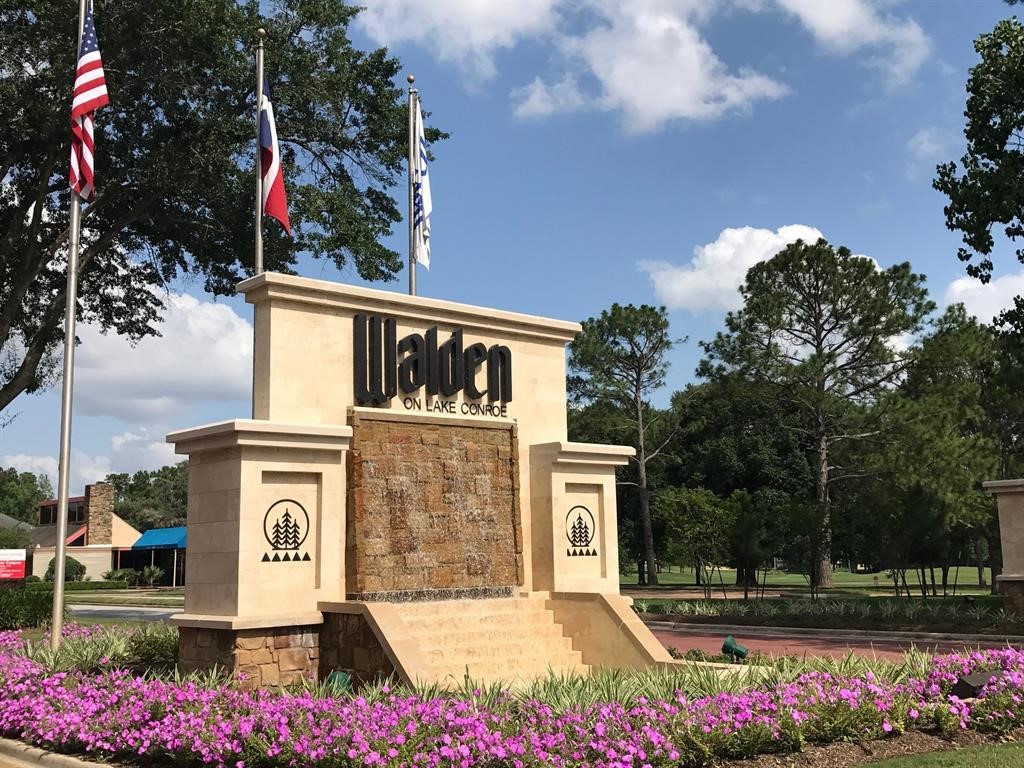 13151 Walden Road, Unit 127 Montgomery, TX 77356 - Photo 28 of 46 a front view of a house with a yard and fountain in middle
