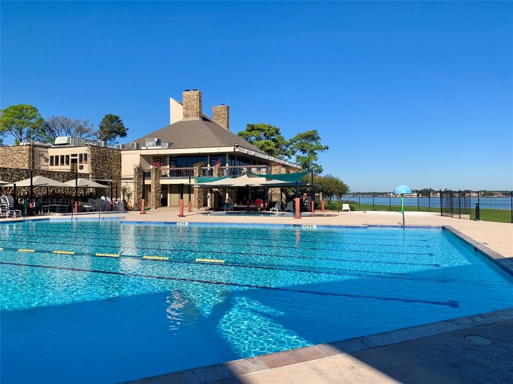 13151 Walden Road, Unit 127 Montgomery, TX 77356 - Photo 34 of 46 a view of a swimming pool with an ocean view