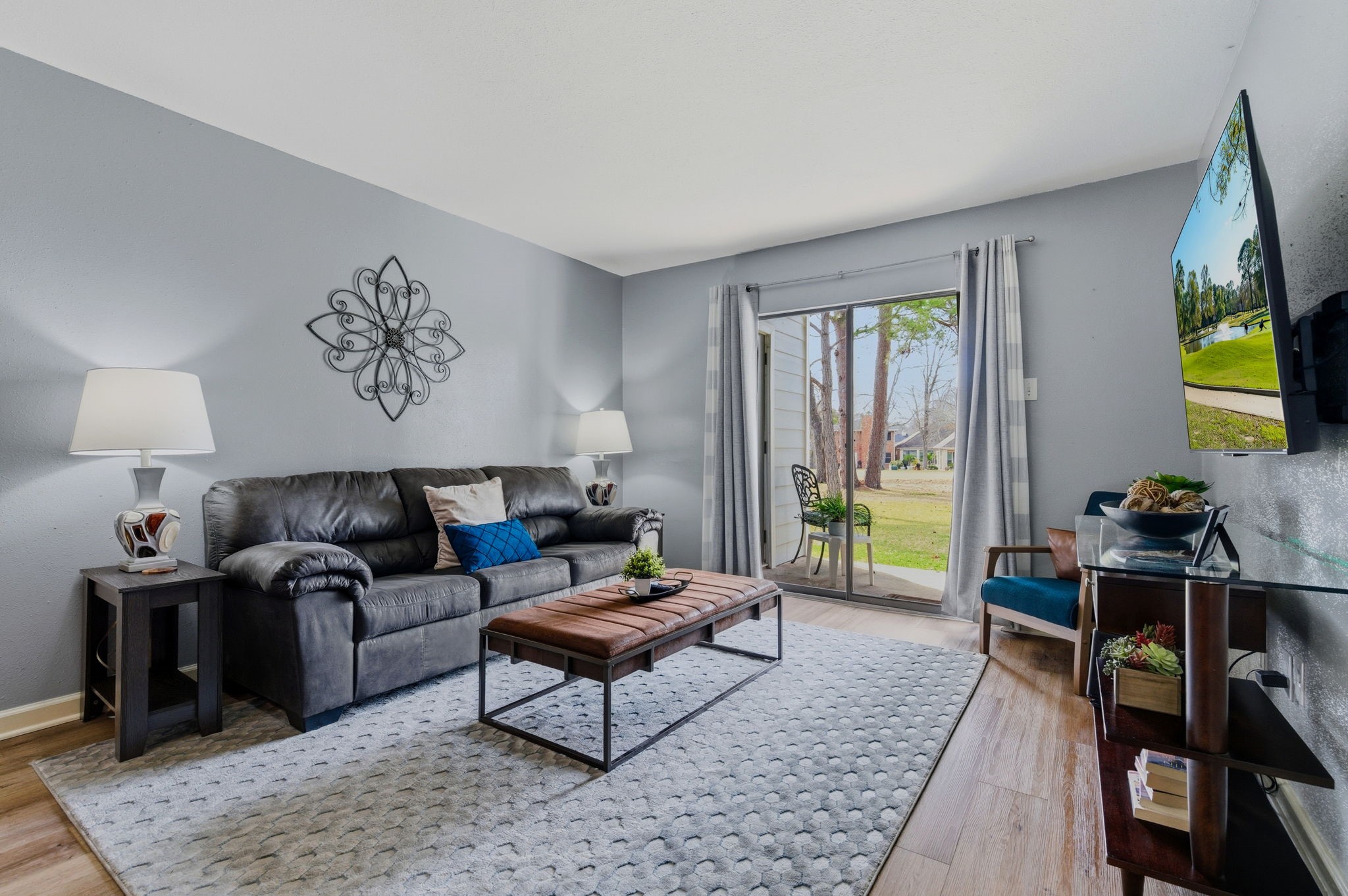 13151 Walden Road, Unit 127 Montgomery, TX 77356 - Photo 4 of 46 a living room with furniture and a flat screen tv