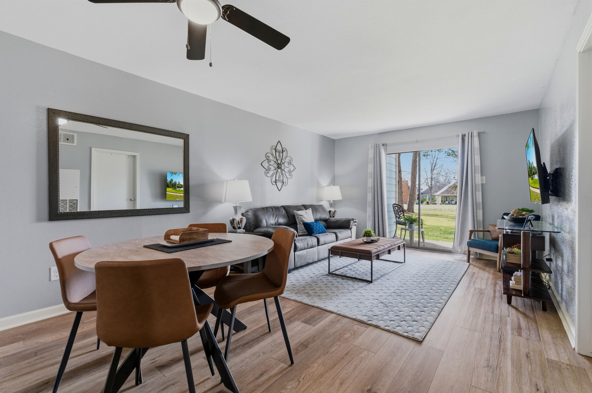 13151 Walden Road, Unit 127 Montgomery, TX 77356 - Photo 5 of 46 a living room with furniture and wooden floor