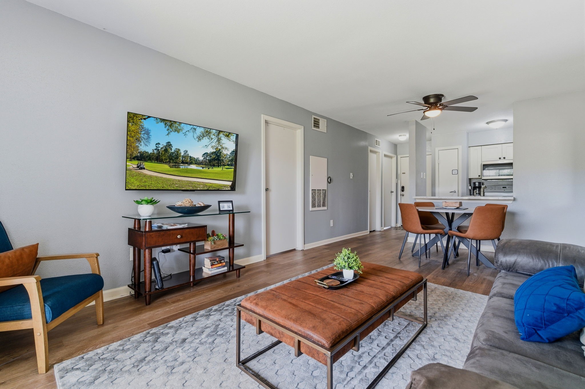 13151 Walden Road, Unit 127 Montgomery, TX 77356 - Photo 6 of 46 a living room with furniture and a flat screen tv
