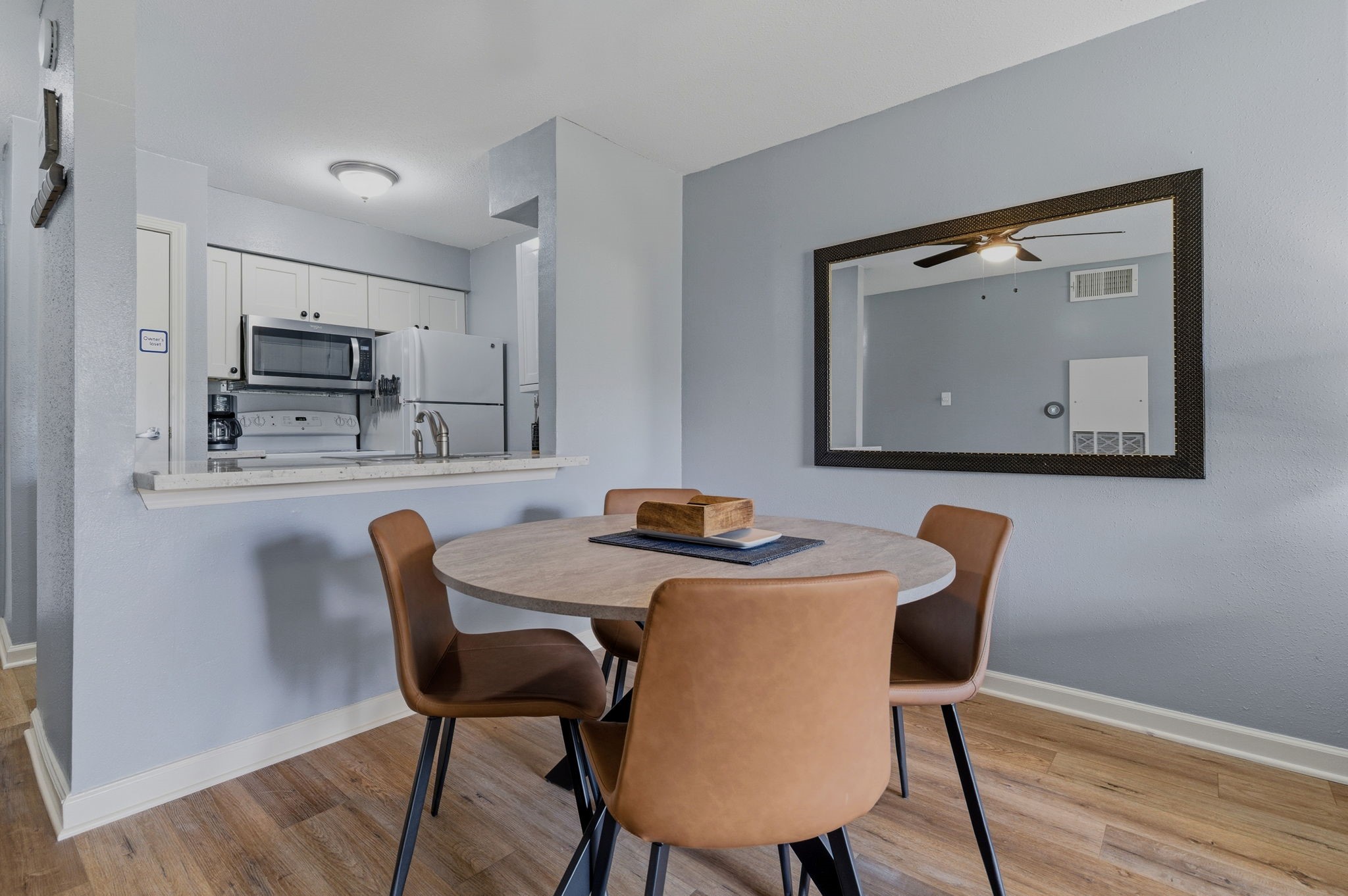13151 Walden Road, Unit 127 Montgomery, TX 77356 - Photo 7 of 46 a view of a dining room with furniture and wooden floor