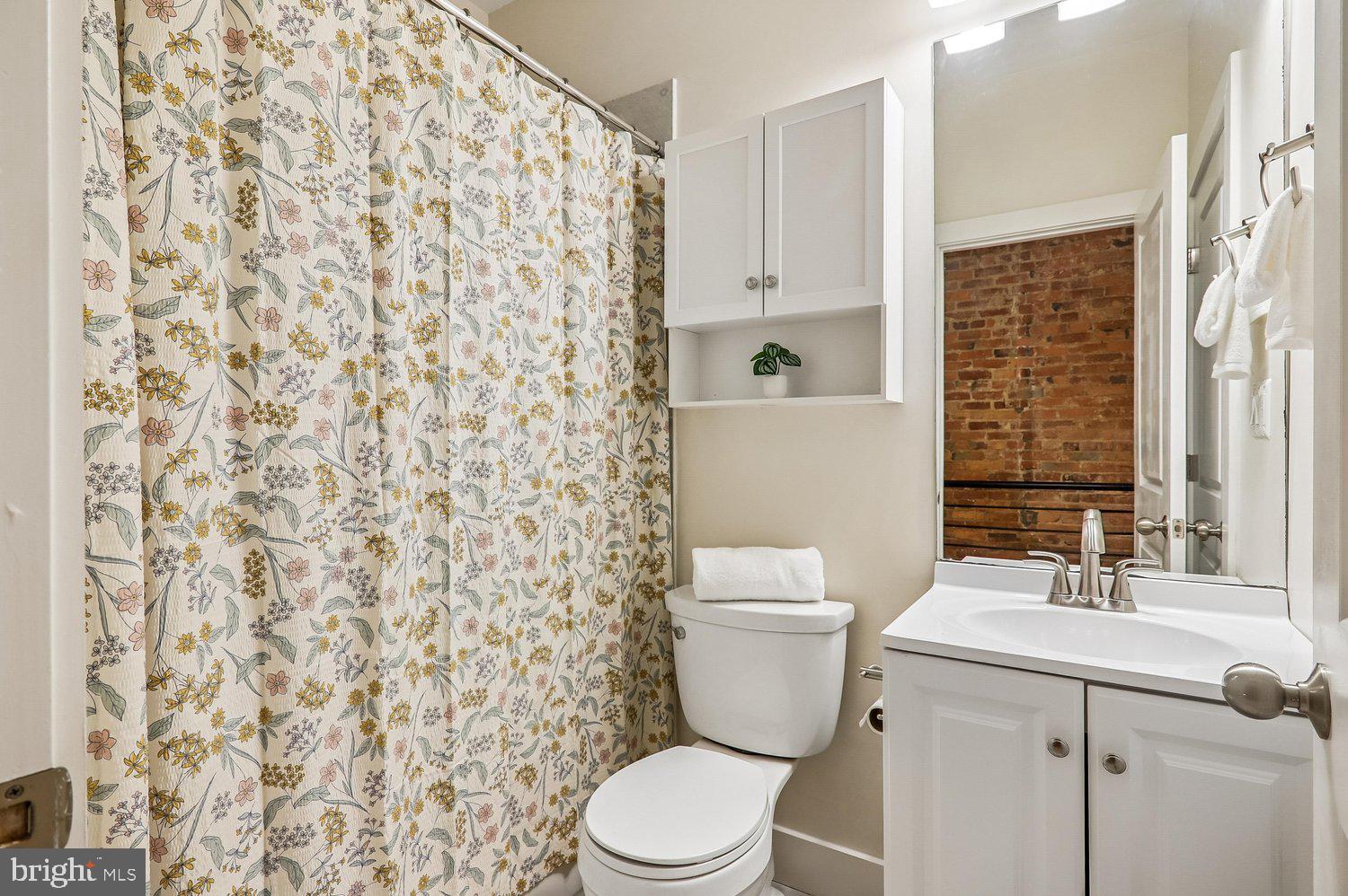 911 L Street Northeast Washington, DC 20002 - Photo 31 of 48 a bathroom with a sink toilet and shower