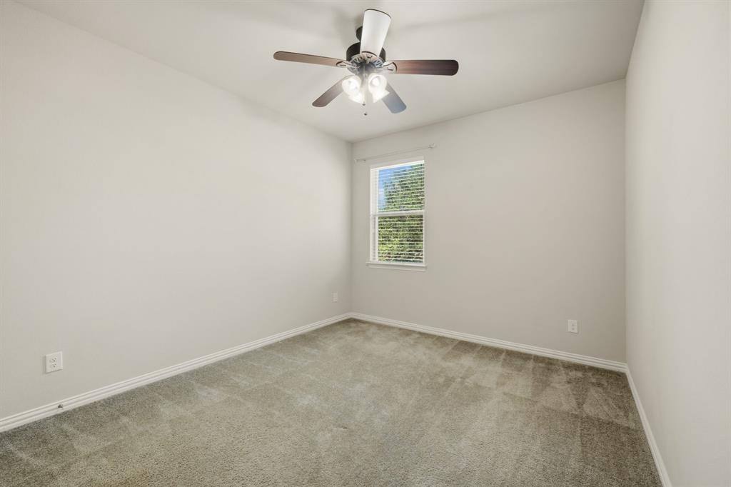 12809 Spring Hill Drive Frisco, TX 75035 - Photo 30 of 37 an empty room with windows and chandelier fan