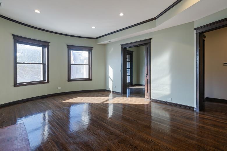444 East 48th Street, Unit 2W Chicago, IL 60615 - Photo 14 of 31 a view of an empty room with wooden floor and windows