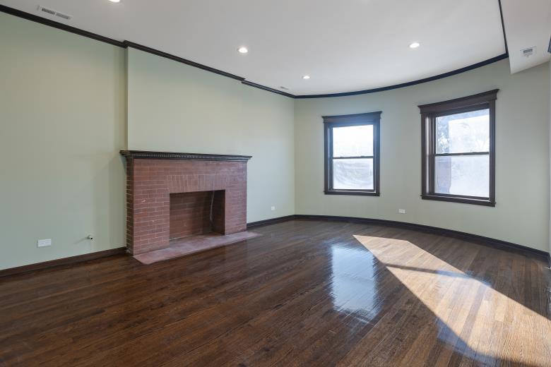 444 East 48th Street, Unit 2W Chicago, IL 60615 - Photo 15 of 31 an empty room with wooden floor fireplace and windows