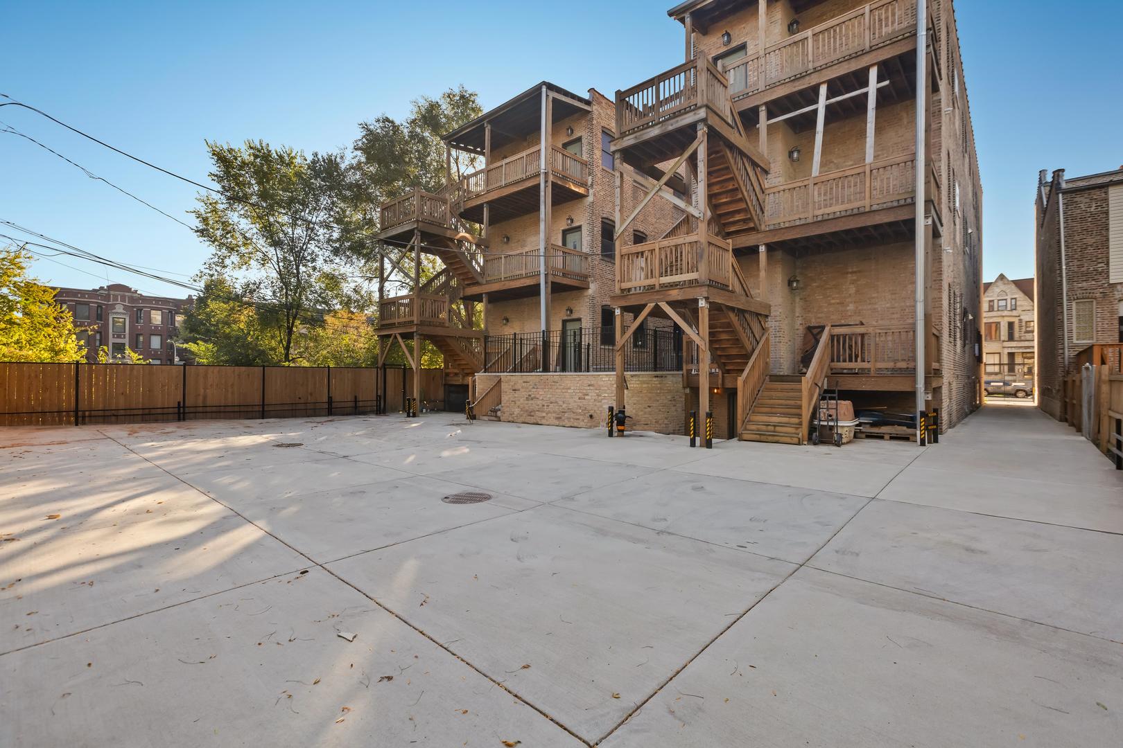 444 East 48th Street, Unit 2W Chicago, IL 60615 - Photo 2 of 31 a view of a building with a yard