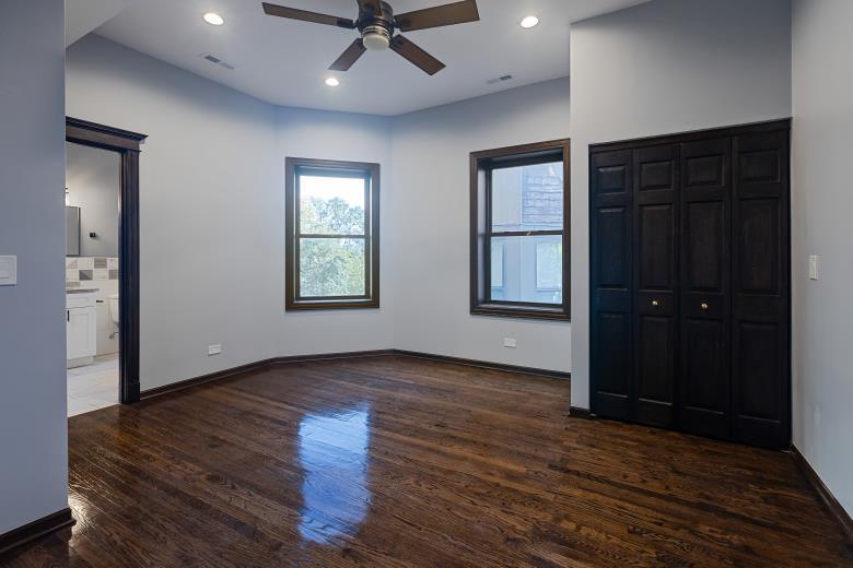 444 East 48th Street, Unit 2W Chicago, IL 60615 - Photo 22 of 31 an empty room with wooden floor closet and windows