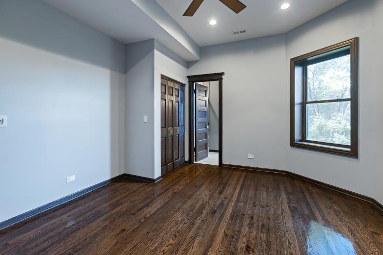444 East 48th Street, Unit 2W Chicago, IL 60615 - Photo 23 of 31 an empty room with wooden floor and windows