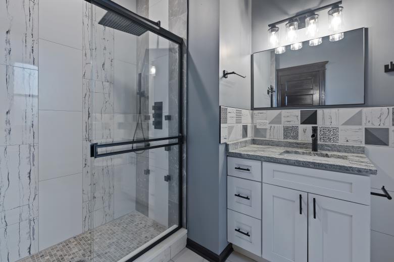 444 East 48th Street, Unit 2W Chicago, IL 60615 - Photo 25 of 31 a bathroom with a granite countertop shower sink and mirror