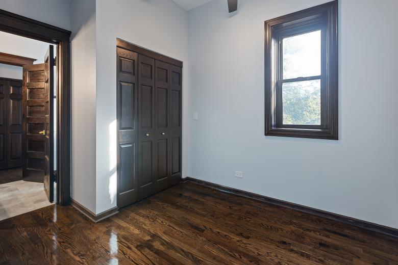 444 East 48th Street, Unit 2W Chicago, IL 60615 - Photo 26 of 31 an empty room with wooden floor and windows