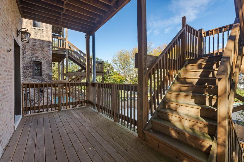 444 East 48th Street, Unit 2W Chicago, IL 60615 - Photo 30 of 31 a view of staircase with wooden floor and fence