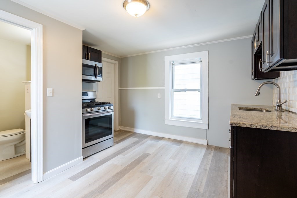 a kitchen with stainless steel appliances a stove and a sink