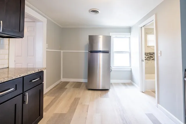 a kitchen with a refrigerator and a sink