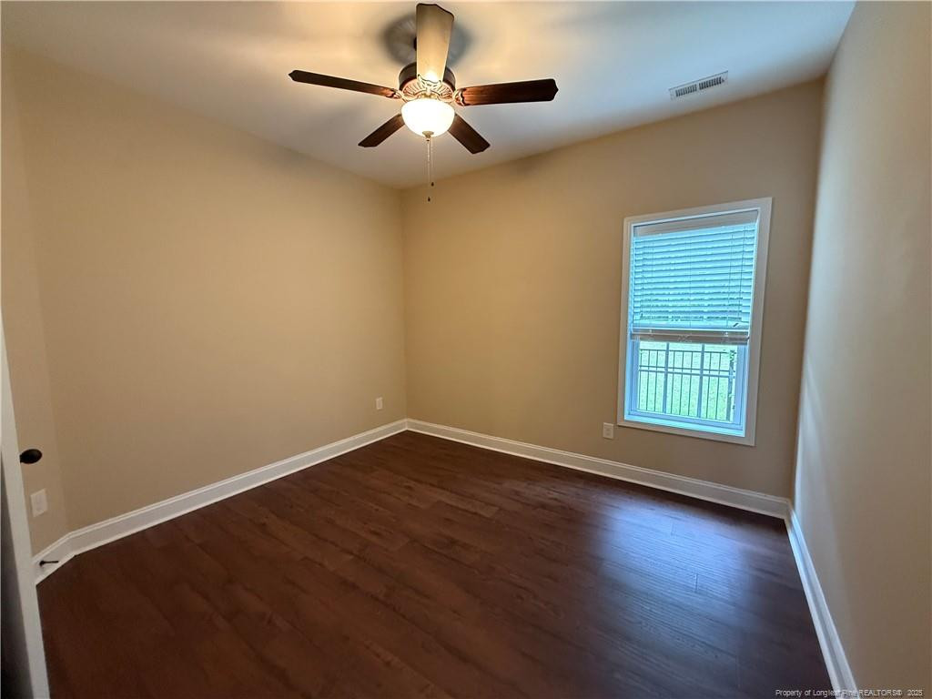 Undisclosed Address Spring Lake, NC 28390 - Photo 11 of 21 a view of an empty room with wooden floor and a window