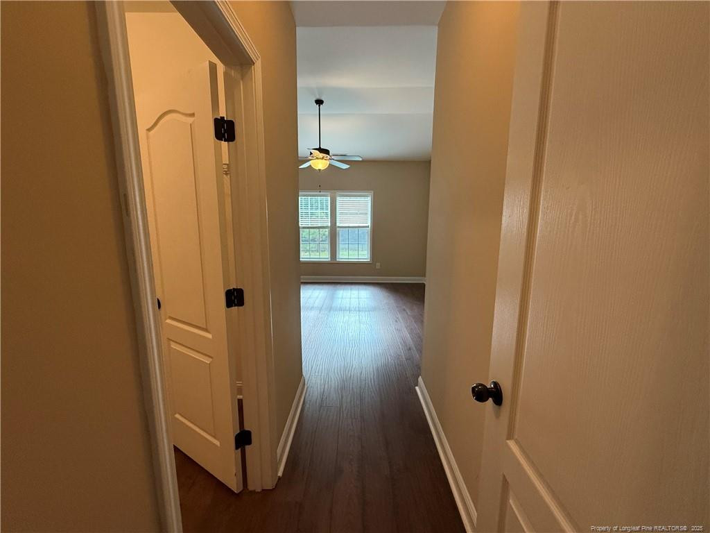Undisclosed Address Spring Lake, NC 28390 - Photo 12 of 21 a view of a hallway with wooden floor and stairs