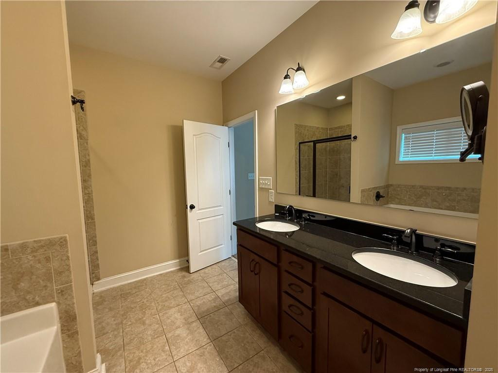 Undisclosed Address Spring Lake, NC 28390 - Photo 16 of 21 a bathroom with a granite countertop sink and a mirror