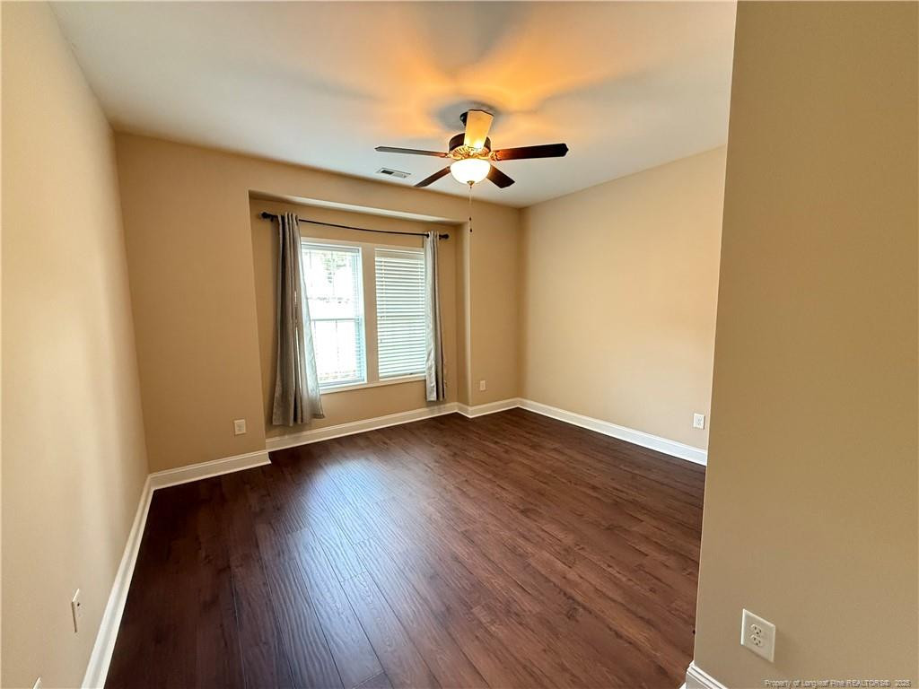 Undisclosed Address Spring Lake, NC 28390 - Photo 18 of 21 an empty room with wooden floor fan and window