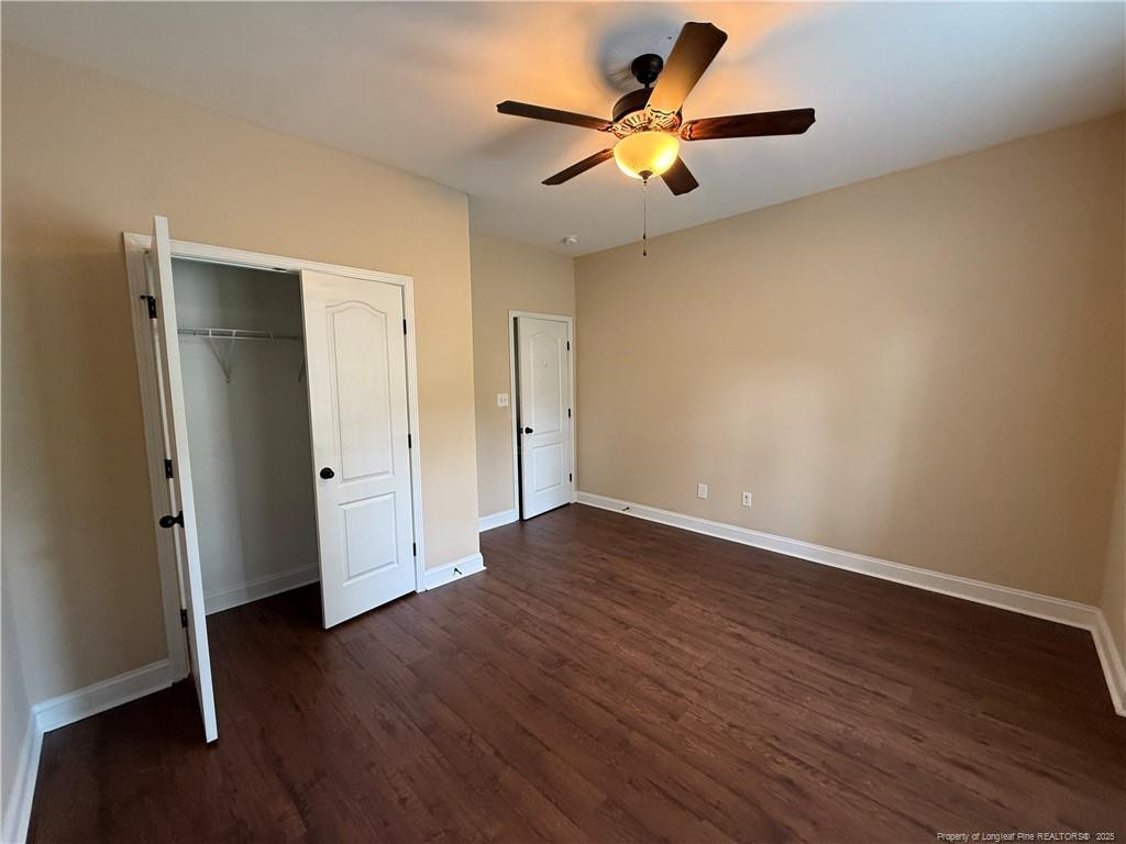 Undisclosed Address Spring Lake, NC 28390 - Photo 19 of 21 an empty room with wooden floor and a ceiling fan