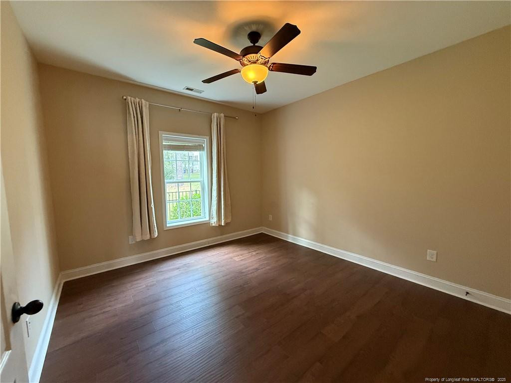 Undisclosed Address Spring Lake, NC 28390 - Photo 2 of 21 an empty room with wooden floor and ceiling fan