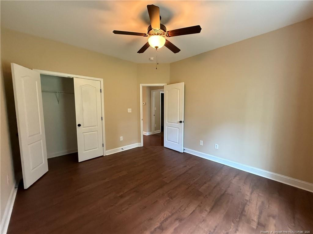 Undisclosed Address Spring Lake, NC 28390 - Photo 3 of 21 a view of an empty room with window and wooden floor