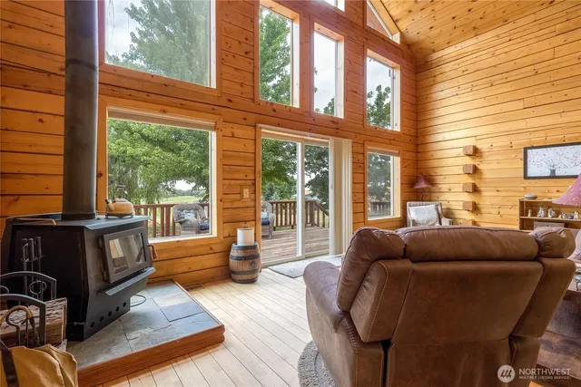 a living room filled with furniture and floor to ceiling windows