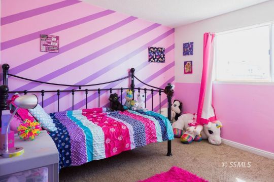 308 West Howell Avenue Ridgecrest, CA 93555 - Photo 24 of 32 a bedroom with a bed and a white walls