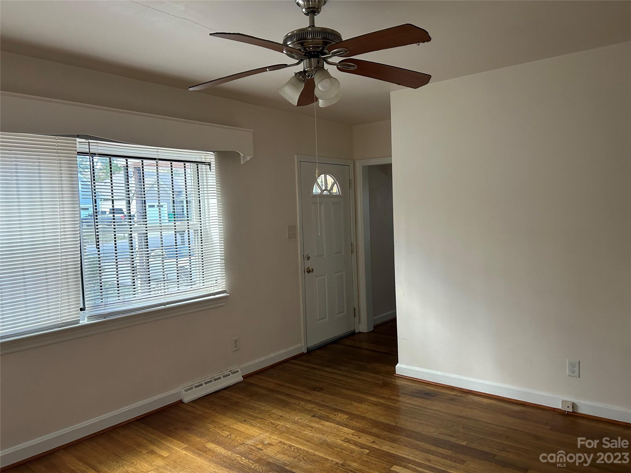 2012 Gilbert Street Charlotte, NC 28216 - Photo 4 of 13 a view of an empty room with window and wooden floor